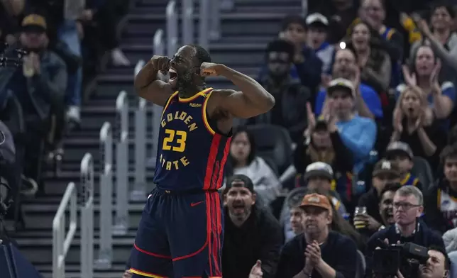 Golden State Warriors forward Draymond Green reacts after scoring against the Miami Heat during the first half of an NBA basketball game Tuesday, Jan. 7, 2025, in San Francisco. (AP Photo/Godofredo A. Vásquez)