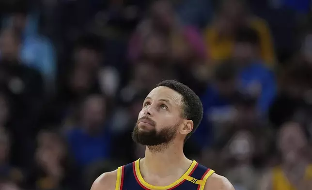 Golden State Warriors guard Stephen Curry looks to the scoreboard during the second half of an NBA basketball game against the Miami Heat, Tuesday, Jan. 7, 2025, in San Francisco. (AP Photo/Godofredo A. Vásquez)