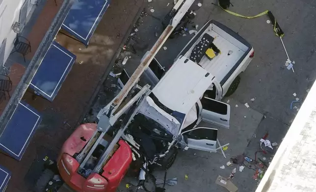 FILE - An Islamic State flag lies on the ground rolled up behind the pickup truck that Shamsud-Din Jabbar drove into a crowd on Bourbon Street in New Orleans on Wednesday, Jan. 1, 2025. (AP Photo/Gerald Herbert, File)