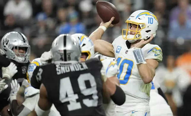 Los Angeles Chargers quarterback Justin Herbert (10) passes against the Las Vegas Raiders during the second half of an NFL football game in Las Vegas, Sunday, Jan. 5, 2025. (AP Photo/John Locher)