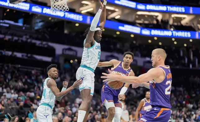 Charlotte Hornets center Mark Williams (5) disrupts a play between Phoenix Suns forward Ryan Dunn (0) and center Mason Plumlee (22) during the first half of an NBA basketball game in Charlotte, N.C., Tuesday, Jan. 7, 2025. (AP Photo/Jim Dedmon)