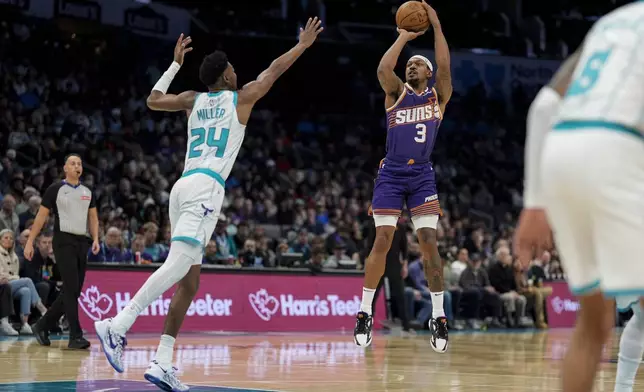 Phoenix Suns guard Bradley Beal (3) shoots a three pointer against Charlotte Hornets forward Brandon Miller (24) during the first half of an NBA basketball game in Charlotte, N.C., Tuesday, Jan. 7, 2025. (AP Photo/Jim Dedmon)