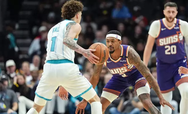 Phoenix Suns guard Bradley Beal (3) on defense against Charlotte Hornets guard LaMelo Ball (1) during the first half of an NBA basketball game in Charlotte, N.C., Tuesday, Jan. 7, 2025. (AP Photo/Jim Dedmon)