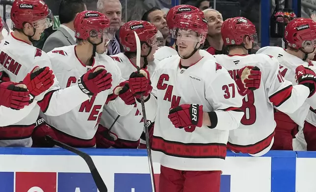 Carolina Hurricanes right wing Andrei Svechnikov (37) celebrates with the bench after his goal against the Tampa Bay Lightning during the second period of an NHL hockey game Tuesday, Jan. 7, 2025, in Tampa, Fla. (AP Photo/Chris O'Meara)