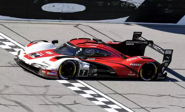 Felipe Nasr, of Brazil, crosses the finish line in his Porsche 963 to win the IMSA Rolex 24 hour auto race at Daytona International Speedway, Sunday, Jan. 26, 2025, in Daytona Beach, Fla. (AP Photo/John Raoux)