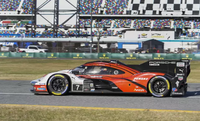 Laurens Vanthoor, of Belgium, comes out of a turn in the Porsche 963 during IMSA Rolex 24 hour auto race at Daytona International Speedway, Sunday, Jan. 26, 2025, in Daytona Beach, Fla. (AP Photo/John Raoux)