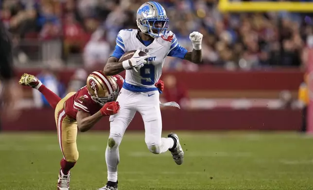 Detroit Lions wide receiver Jameson Williams (9) is tackled by San Francisco 49ers cornerback Deommodore Lenoir (2) during the second half of an NFL football game Monday, Dec. 30, 2024, in Santa Clara, Calif. (AP Photo/Godofredo A. Vásquez)