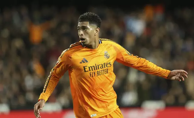 Real Madrid's Jude Bellingham celebrates after scoring his side's 2nd goal against Valencia during a Spanish La Liga soccer match at Mestalla stadium in Valencia, Spain, Friday, Jan. 3, 2025. (AP Photo/Alberto Saiz)