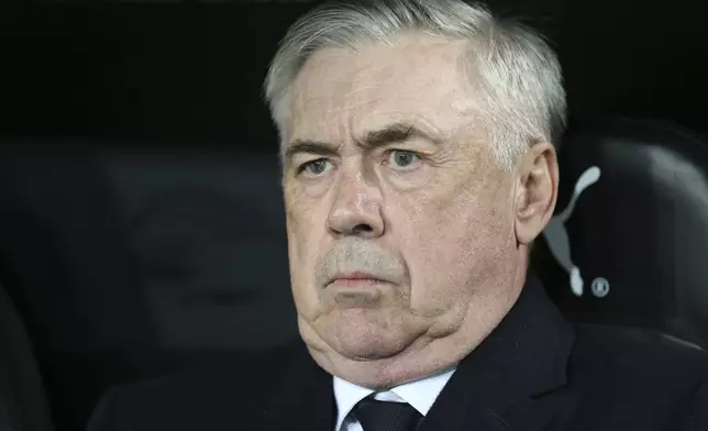 Real Madrid's coach Carlo Ancelotti waits for the beginning of a Spanish La Liga soccer match against Valencia at Mestalla stadium in Valencia, Spain, Friday, Jan. 3, 2025. (AP Photo/Alberto Saiz)