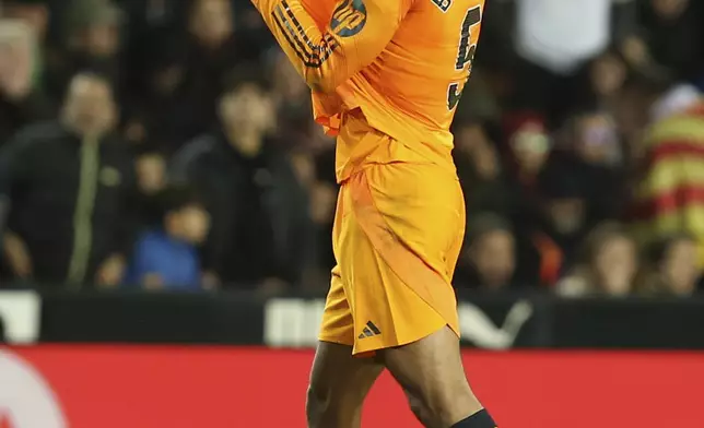 Real Madrid's Jude Bellingham celebrates after scoring his side's 2nd goal against Valencia during a Spanish La Liga soccer match at Mestalla stadium in Valencia, Spain, Friday, Jan. 3, 2025. (AP Photo/Alberto Saiz)