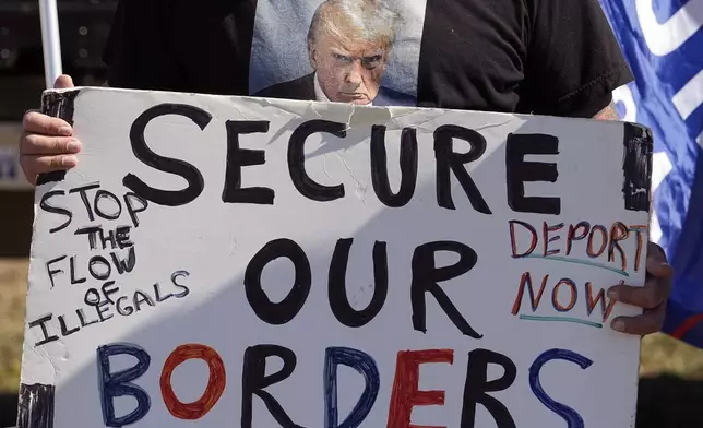 FILE - Phill Cady wears a t-shirt with a photo of former President Donald Trump, who is running for reelection, as he holds a sign during a "Take Our Border Back" rally on Feb. 3, 2024, in Quemado, Texas. (AP Photo/Eric Gay, File)