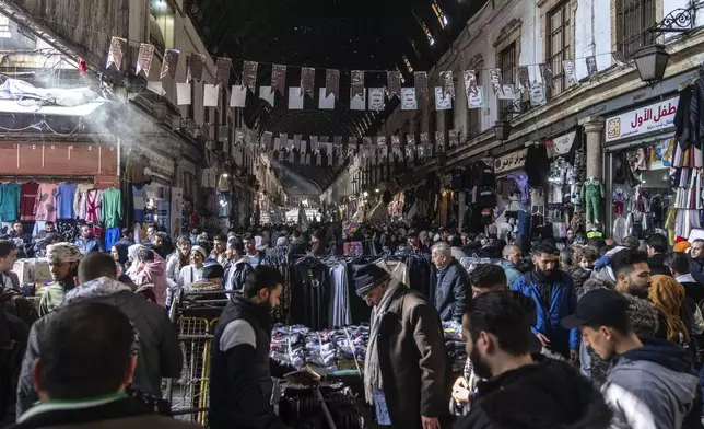 People shop for goods near Al-Hamidiyeh Souq on New Years Eve, in Damascus, Syria, Tuesday, Dec. 31, 2024 (AP Photo/Mosa'ab Elshamy)