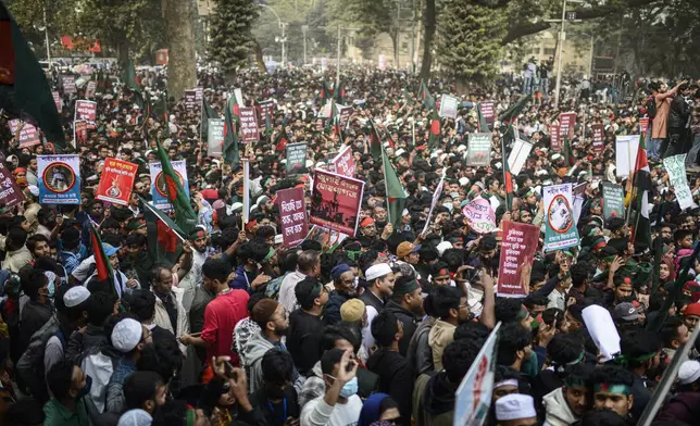 Participants, mostly students, carry placards and shout slogans during "March for Unity" organized by The Anti-Discrimination Student Movement at the Central Shaheed Minar, a national monument, in Dhaka, Bangladesh, Tuesday, Dec. 31, 2024. (AP Photo/Mahmud Hossain Opu)