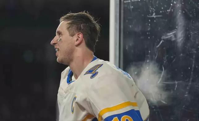 St. Louis Blues center Brayden Schenn leaves the ice after getting a five-minute major for fighting with Chicago Blackhawks left wing Nick Foligno during the second period of the NHL Winter Classic outdoor hockey game at Wrigley Field, Tuesday, Dec. 31, 2024, in Chicago. (AP Photo/Erin Hooley)