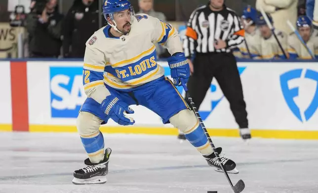 St. Louis Blues defenseman Justin Faulk (72) handles the puck during the second period of the NHL Winter Classic outdoor hockey game against the Chicago Blackhawks at Wrigley Field, Tuesday, Dec. 31, 2024, in Chicago. (AP Photo/Erin Hooley)