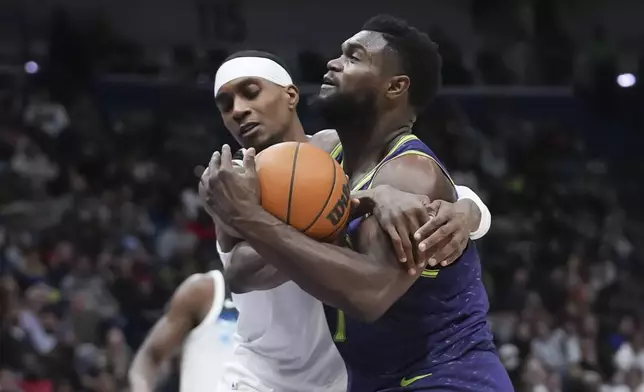 New Orleans Pelicans forward Zion Williamson is fouled by Minnesota Timberwolves forward Jaden McDaniels as he drives to the basket in the second half of an NBA basketball game in New Orleans, Tuesday, Jan. 7, 2025. The Timberwolves won 104-97. (AP Photo/Gerald Herbert)