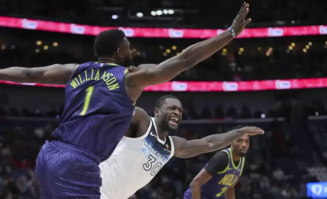 New Orleans Pelicans forward Zion Williamson (1) battles for the ball against Minnesota Timberwolves forward Julius Randle (30) in the first half of an NBA basketball game in New Orleans, Tuesday, Jan. 7, 2025. (AP Photo/Gerald Herbert)