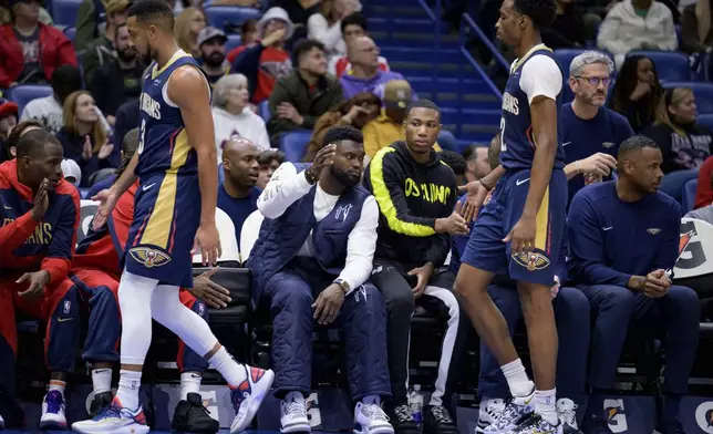 New Orleans Pelicans forward Zion Williamson, arm raised, high fives his teammates during the first half of an NBA basketball game against the Washington Wizards in New Orleans, Friday, Jan. 3, 2025. (AP Photo/Matthew Hinton)