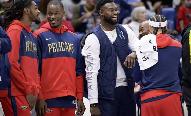 New Orleans Pelicans forward Zion Williamson, third from left, celebrates during the second half of an NBA basketball game against the Washington Wizards in New Orleans, Friday, Jan. 3, 2025. (AP Photo/Matthew Hinton)