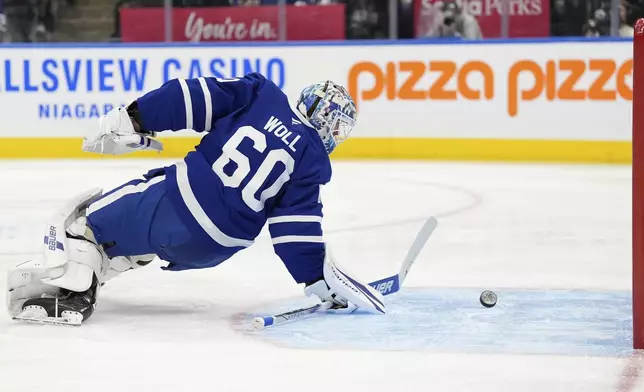 Toronto Maple Leafs goalie Joseph Woll (60) gathers the puck after it struck the post without scoring during the first period of an NHL hockey game against the Boston Bruins in Toronto, Saturday, Jan. 4, 2025. (Frank Gunn/The Canadian Press via AP)