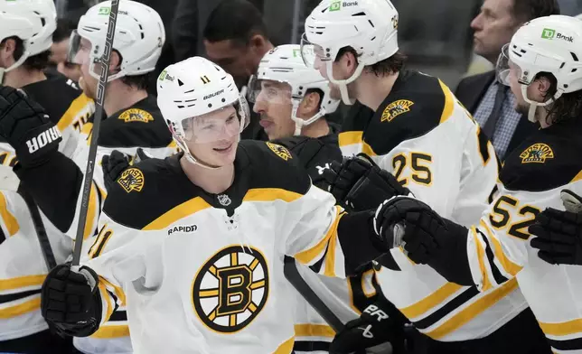 Boston Bruins center Trent Frederic (11) celebrates his goal with teammates on the bench during the second period of an NHL hockey game against the Toronto Maple Leafs in Toronto, Saturday, Jan. 4, 2025. (Frank Gunn/The Canadian Press via AP)