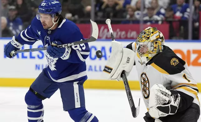 Toronto Maple Leafs left wing Nicholas Robertson (89) tries for a deflection on Boston Bruins goalie Jeremy Swayman (1) during the second period of an NHL hockey game in Toronto, Saturday, Jan. 4, 2025. (Frank Gunn/The Canadian Press via AP)