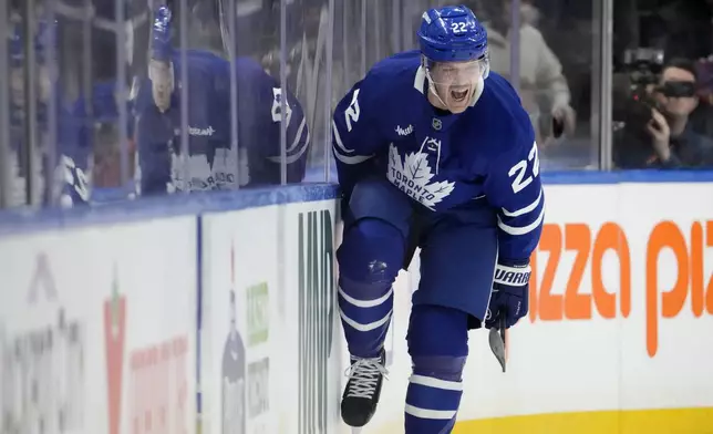 Toronto Maple Leafs defenseman Jake McCabe (22) celebrates his goal during the first period of an NHL hockey game against the Boston Bruins in Toronto, Saturday, Jan. 4, 2025. (Frank Gunn/The Canadian Press via AP)