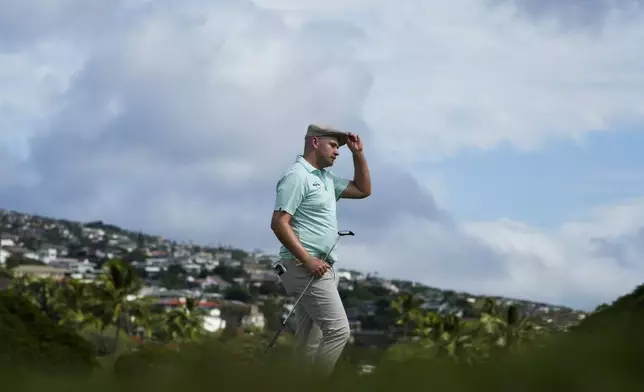 Harry Hall, of England, tips his hat after birdieing the 18th hole during the first round of the Sony Open golf event, Thursday, Jan. 9, 2025, at Waialae Country Club in Honolulu. (AP Photo/Matt York)