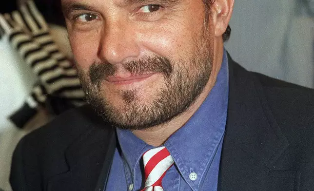 FILE - Benetton creative director and photographer Oliviero Toscani smiles in this 1993 file photo taken in Milan, Italy. (AP Photo/Luca Bruno, File)