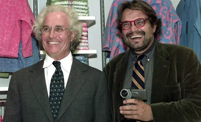 FILE - Luciano Benetton, left, and photographer Oliviero Toscani pose for photographers, in Milan, Italy, on Sept. 29, 1998. (AP Photo/Luca Bruno, File)