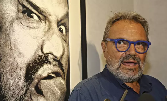 Italian photographer Oliviero Toscani is pictured in front of one of his works, a self-portrait, at the former Church of St. Pier Scheraggio, in Florence, Italy, Sept. 7, 2016. (Leonardo Bianchi/LaPresse via AP)