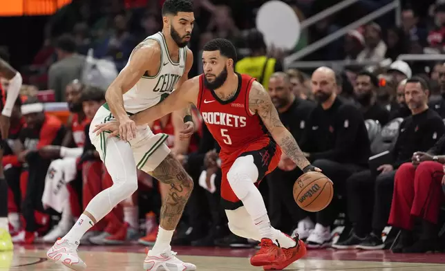 Boston Celtics' Jayson Tatum, left, defends against Houston Rockets' Fred VanVleet (5) during the first half of an NBA basketball game Friday, Jan. 3, 2025, in Houston. (AP Photo/David J. Phillip)