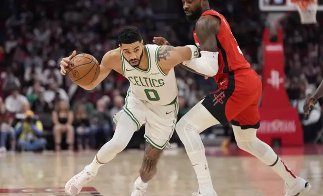 Boston Celtics' Jayson Tatum (0) is fouled by Houston Rockets' Jeff Green during the first half of an NBA basketball game Friday, Jan. 3, 2025, in Houston. (AP Photo/David J. Phillip)