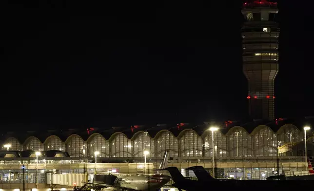 An American Airlines plane is parked at a gate at Ronald Reagan Washington National Airport, Wednesday, Jan. 29, 2025, in Arlington, Va. (AP Photo/Mark Schiefelbein)