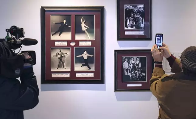 Journalists photograph a memorial to local skaters killed in a 1961 plane crash at The Skating Club of Boston, Thursday, Jan. 30, 2025, in Norwood, Mass. (AP Photo/Charles Krupa)