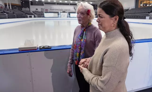 Former Olympic skater Nancy Kerrigan, right, walks with fellow Olympic skater Tenley Albright, at The Skating Club of Boston, where six members of the club's community, including athletes, coaches and family, were killed in an airplane collision with a helicopter on Wednesday in Washington, Thursday, Jan. 30, 2025, in Norwood, Mass. (AP Photo/Charles Krupa)