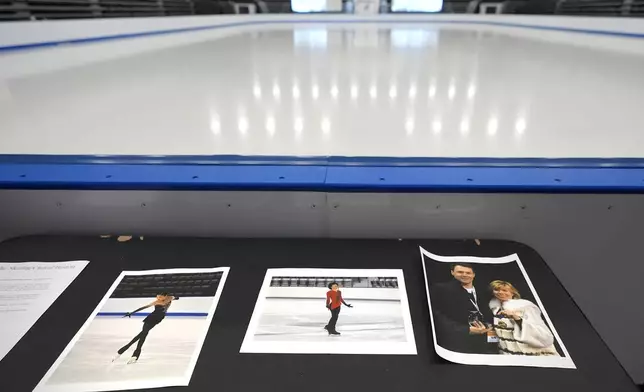 Photographs of aircraft crash victims from The Skating Club of Boston rink are displayed rink side, Thursday, Jan. 30, 2025, in Norwood, Mass. From left is skater Jinna Han, skater Spencer Lane and coaches Vadim Naumov and Evgenia Shishkova. (AP Photo/Charles Krupa)