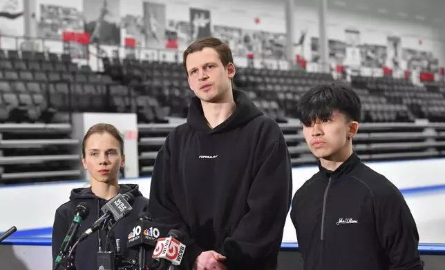 American figure skaters, from the left, Alisa Efimova, Misha Mitrofanov, and Jimmy Ma, speak to members of the media at the The Skating Club of Boston, where several athletes, coaches and family associated with the club are believed to have perished in the collision of a passenger aircraft and military helicopter in Washington, Thursday, Jan. 30, 2025, in Norwood, Mass. (AP Photo/Steven Senne)