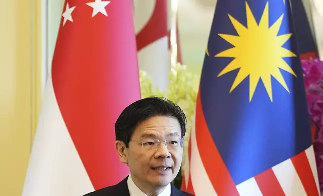 Singapore Prime Minister Lawrence Wong speaks during a press conference with Malaysian Prime Minister Anwar Ibrahim at the prime minister's office in Putrajaya, Malaysia, Tuesday, Jan. 7, 2025. (AP Photo/Vincent Thian, Pool)