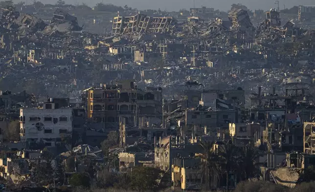 Destroyed buildings are seen inside the Gaza Strip from southern Israel, Monday, Jan. 13, 2025. (AP Photo/Ariel Schalit)