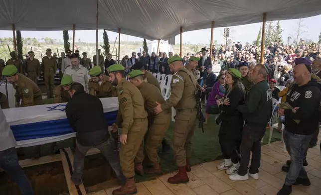 Israeli soldiers and relatives carry the flag-draped casket of Sergeant Yahav Maayan, who was killed in combat in the Gaza Strip, during his funeral at a military cemetery in Modiin, Israel, Sunday, Jan. 12, 2025. (AP Photo/Ohad Zwigenberg)