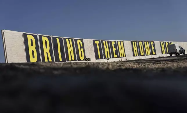 An Israeli military car drives by a protective wall near the border with Gaza Strip, in southern Israel, Monday, Jan. 13, 2025. (AP Photo/Ariel Schalit)