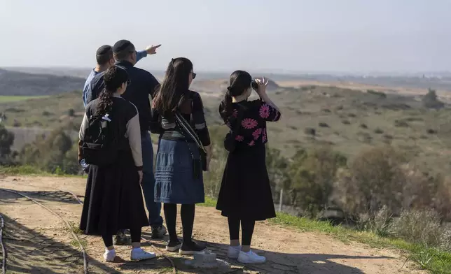 People watch the Gaza Strip from an observation point in Sderot, southern Israel, Monday, Jan. 13, 2025. (AP Photo/Ariel Schalit)