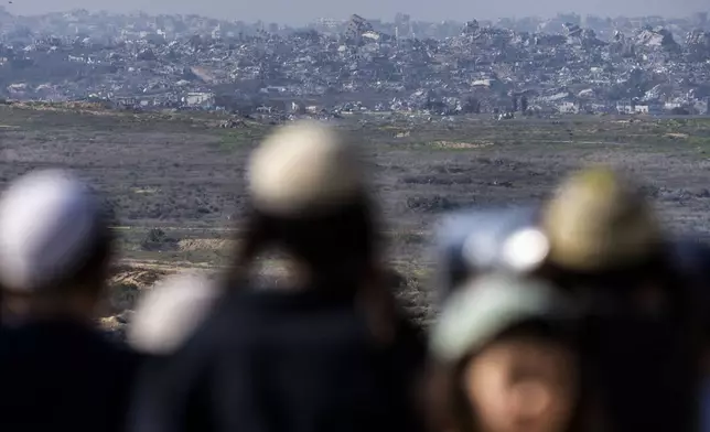 People watch the Gaza Strip from an observation point in Sderot, southern Israel, Monday, Jan. 13, 2025. (AP Photo/Ariel Schalit)