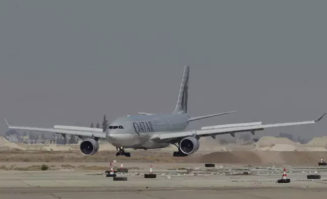 Qatar Airways plane a first international commercial flight since the fall of former Syrian President Bashar Assad, landing at Damascus international airport arriving from Qatar, in Damascus, Syria, Tuesday, Jan. 7, 2025. (AP Photo/Omar Sanadiki)