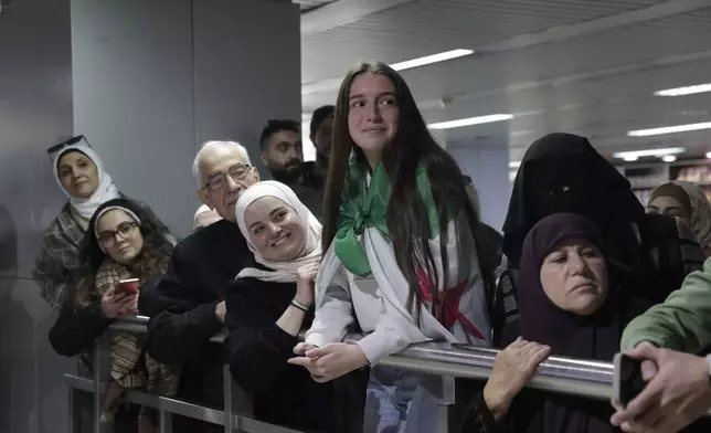 People wait to receive their relatives at the arrival terminal, after a first international commercial flight since the fall of former Syrian President Bashar Assad landed at Damascus international airport, in Damascus, Syria, Tuesday, Jan. 7, 2025. (AP Photo/Omar Sanadiki)