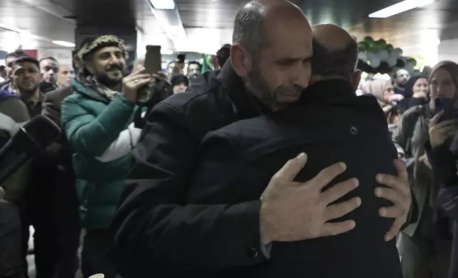 A Syrian man hugs a relative at the arrival terminal, after a first international commercial flight since the fall of former Syrian President Bashar Assad landed at Damascus international airport, in Damascus, Syria, Tuesday, Jan. 7, 2025. (AP Photo/Omar Sanadiki)