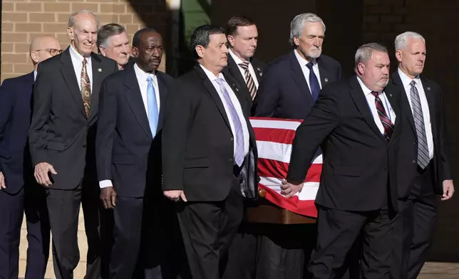 Former and current U.S. Secret Service agents assigned to the Carter detail, carry the flag-draped casket of former President Jimmy Carter, at Phoebe Sumter Medical Center in Americus, Ga., Saturday, Jan. 4, 2025. Carter died Dec. 29 at the age of 100. (AP Photo/Alex Brandon, Pool)