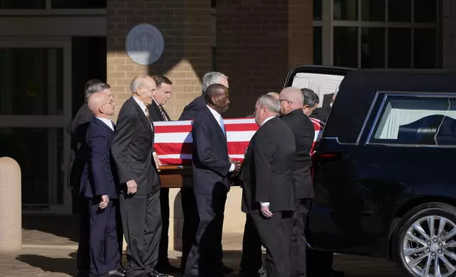 Former and current U.S. Secret Service agents assigned to the Carter detail, move the flag-draped casket of former President Jimmy Carter, at Phoebe Sumter Medical Center in Americus, Ga., Saturday, Jan. 4, 2025. Carter died Dec. 29 at the age of 100. (AP Photo/Alex Brandon, Pool)