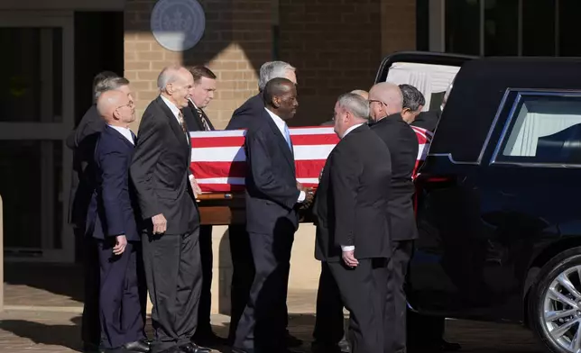 Former and current U.S. Secret Service agents assigned to the Carter detail, move the flag-draped casket of former President Jimmy Carter, at Phoebe Sumter Medical Center in Americus, Ga., Saturday, Jan. 4, 2025. Carter died Dec. 29 at the age of 100. (AP Photo/Alex Brandon, Pool)